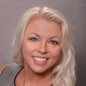 Amber Roelofs, Vice President and General Counsel at Ponaman Healthcare Consulting, smiling with long blonde hair and professional attire.